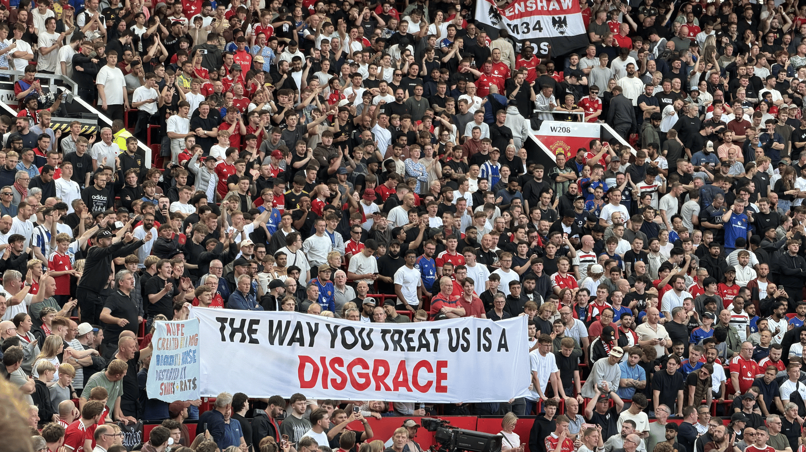 Banner says "The way you treat us is a disgrace" which was shown at Old Trafford during the Manchester City match, and went viral around the world on TV and via media.